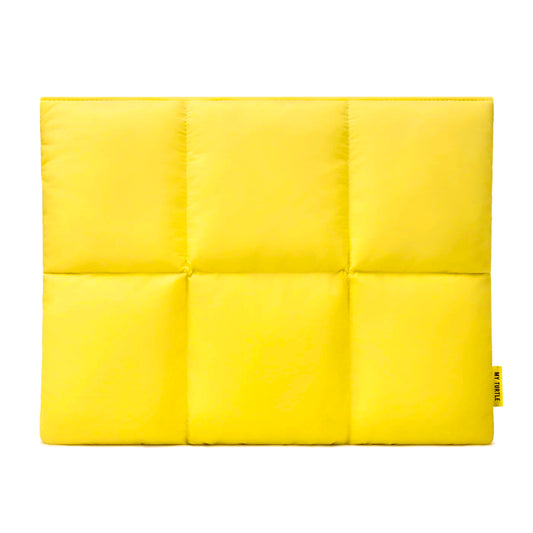 Yellow quilted pouch with a brand tag on a white background
